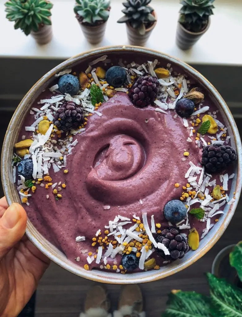 A bowl of delicious, thick and creamy berry ginger smoothie bowl.