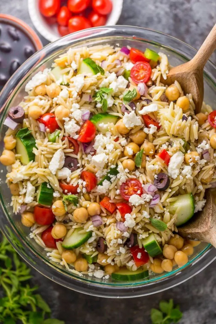 A large bowl of delicious Greek orzo salad.